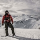 Navy pilot stands on snow covered mountain