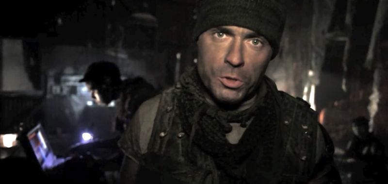 A man in military gear facing camera