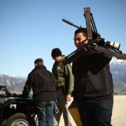 Filmmakers with equipment in Californian desert