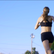 Woman running with big blue sky