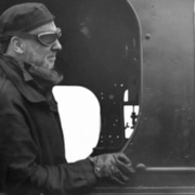 Black and white goggled man on train