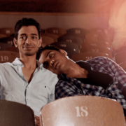 Two men sitting in auditorium