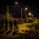 Teenagers on bicycles at night