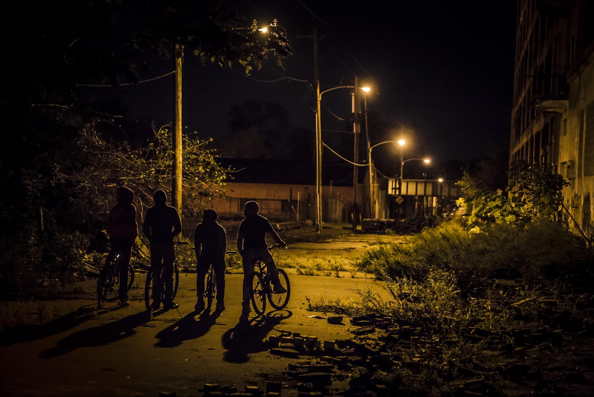 Teenagers on bicycles at night