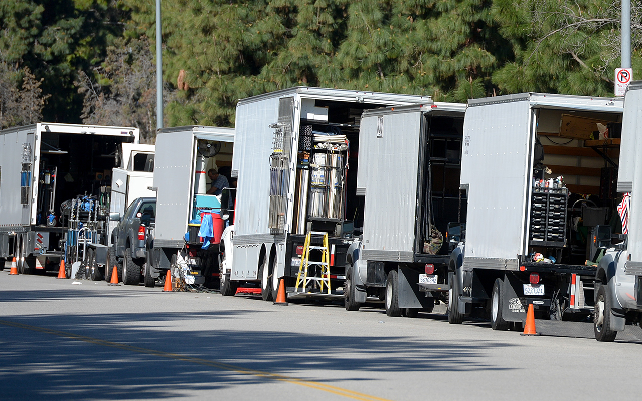 line of parked film trucks