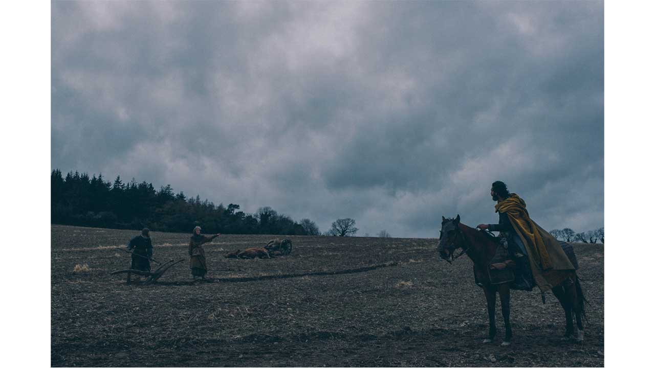 Gawain on horseback in the countryside - The Green Knight