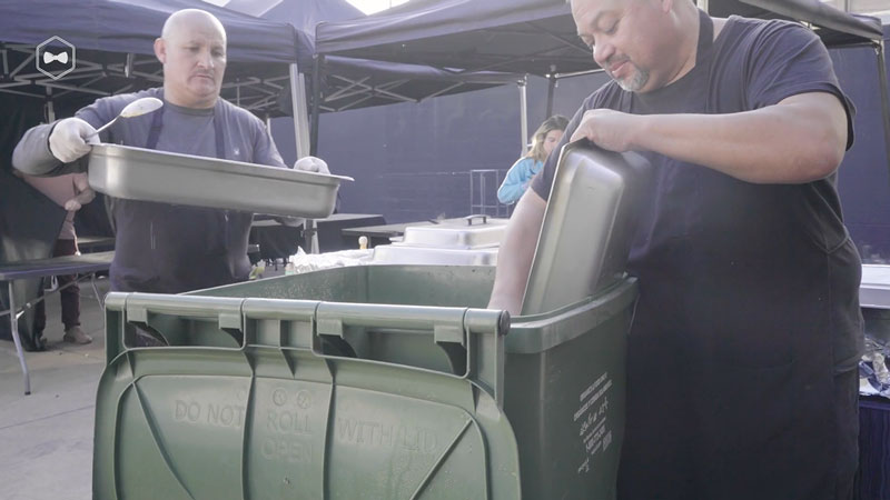 Caterers disposing food waste on film production set