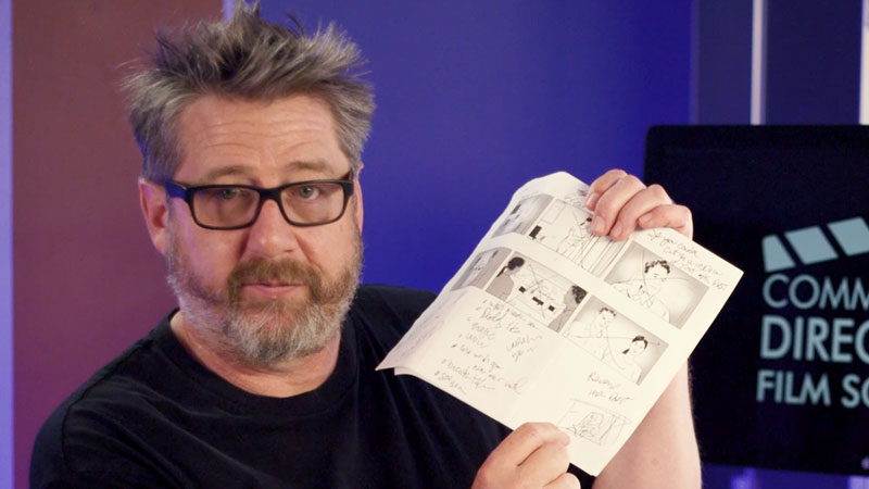 Commercial director Jordan Brady holding storyboards