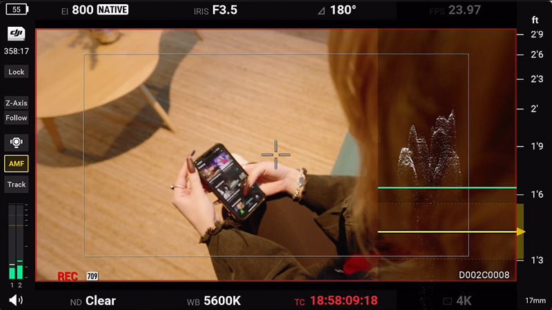 OTS shot of woman looking at phone