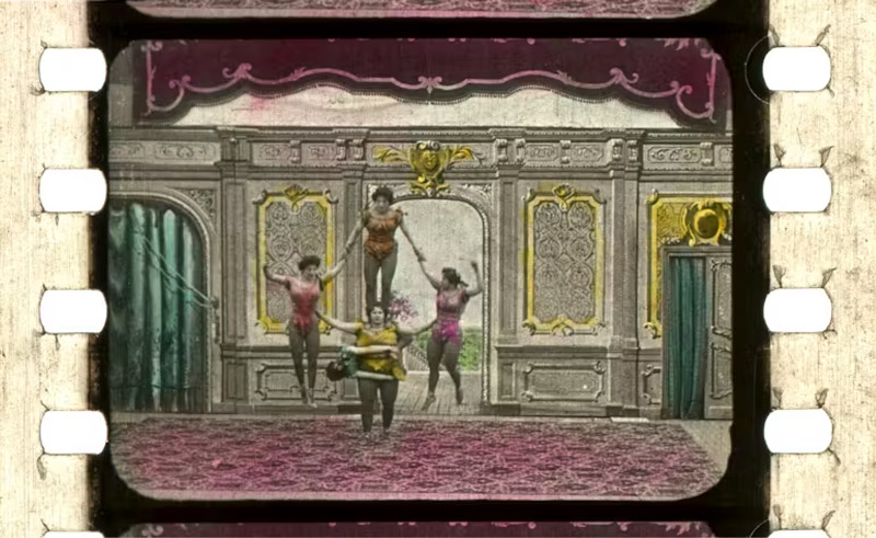 A hand-colored still from the movie Les Six soeurs Dainef (1902)