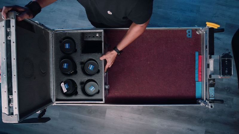 Assistant Camera loads lens cart with lenses 