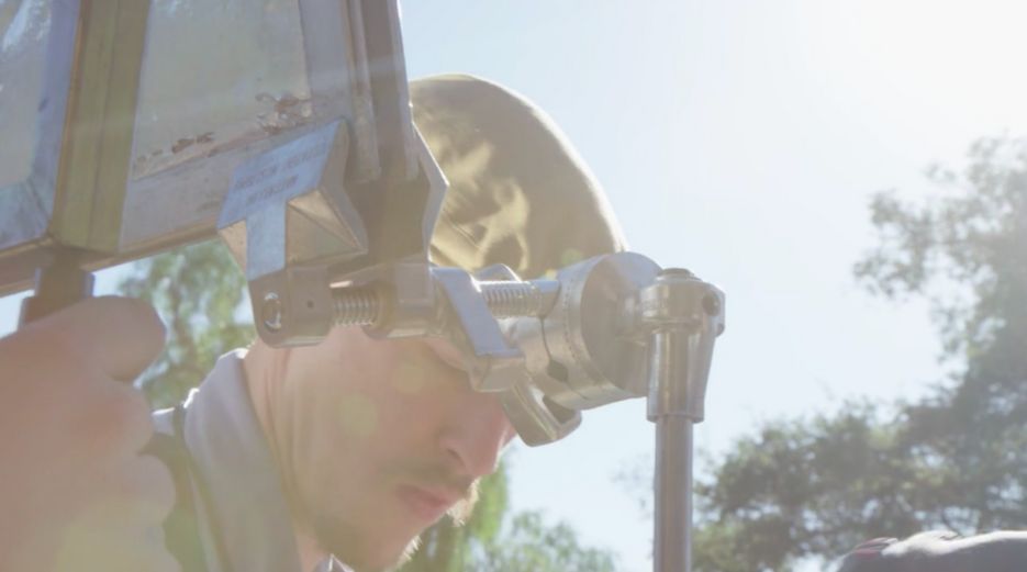 Filmmaker uses a C-stand and Cardellini clamp to grip mirror board