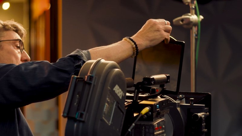 Hand inserting filter tray into film camera